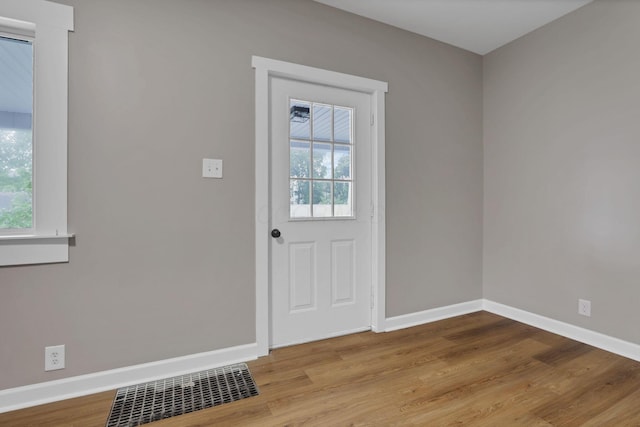 704 N Detroit St, Bellefontaine, OH 43311 - doorway to outside featuring plenty of natural light, wood finished floors, and baseboards
