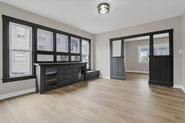 704 N Detroit St, Bellefontaine, OH 43311 - unfurnished living room featuring light wood-type flooring and baseboards