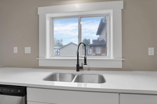 704 N Detroit St, Bellefontaine, OH 43311 - kitchen with a sink, dishwasher, light countertops, and white cabinetry