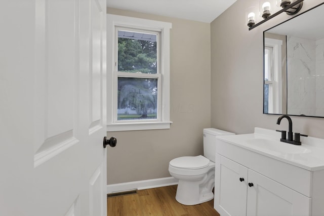 704 N Detroit St, Bellefontaine, OH 43311 - bathroom with vanity, toilet, wood finished floors, baseboards, and a marble finish shower