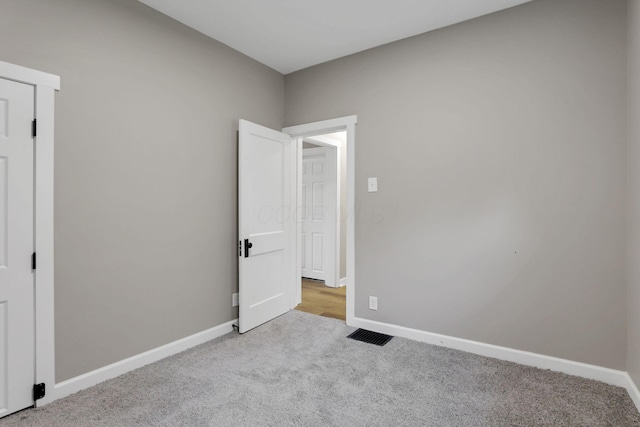704 N Detroit St, Bellefontaine, OH 43311 - unfurnished bedroom with carpet flooring and baseboards