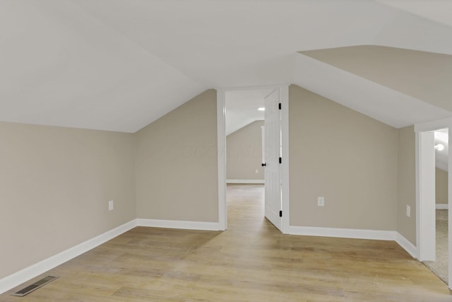 704 N Detroit St, Bellefontaine, OH 43311 - bonus room featuring light wood-style floors, lofted ceiling, and baseboards