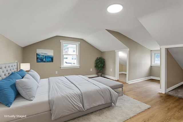 704 N Detroit St, Bellefontaine, OH 43311 - bedroom featuring light wood-type flooring, vaulted ceiling, and baseboards