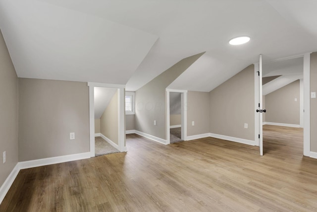 704 N Detroit St, Bellefontaine, OH 43311 - additional living space featuring vaulted ceiling, wood finished floors, and baseboards
