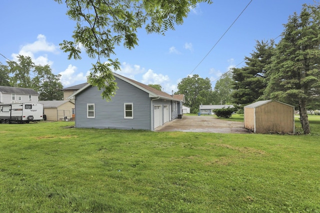 704 N Detroit St, Bellefontaine, OH 43311 - rear view of house featuring a lawn and a detached garage