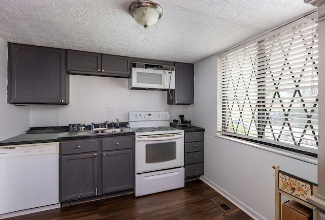 439 Dartmouth Cir Unit 30, Cincinnati, OH 45244 - kitchen featuring white appliances, dark countertops, dark wood-style floors, gray cabinetry, and a textured ceiling