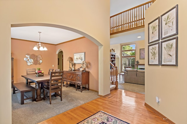 5839 Ketch St, Lewis Center, OH 43035 - dining space featuring arched walkways, wood finished floors, and a chandelier