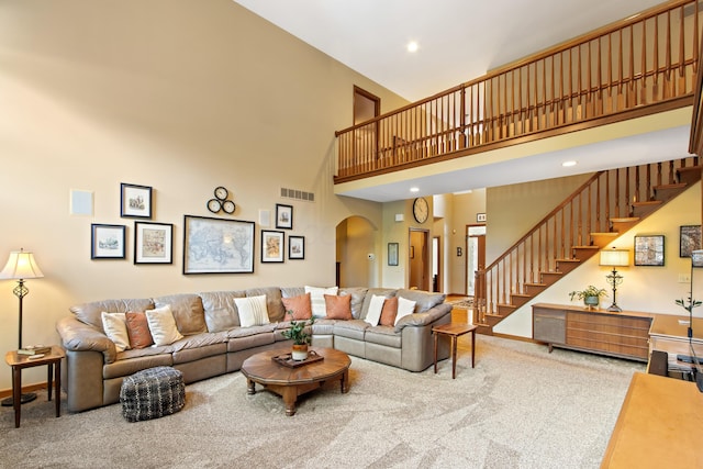 5839 Ketch St, Lewis Center, OH 43035 - carpeted living room featuring a towering ceiling, arched walkways, stairway, and recessed lighting