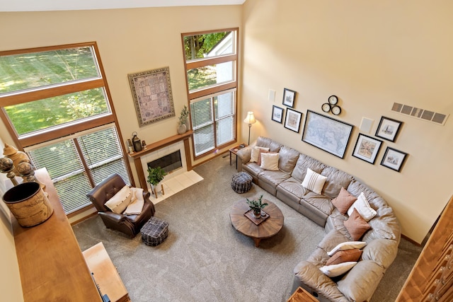 5839 Ketch St, Lewis Center, OH 43035 - carpeted living area with plenty of natural light, a towering ceiling, and a tile fireplace