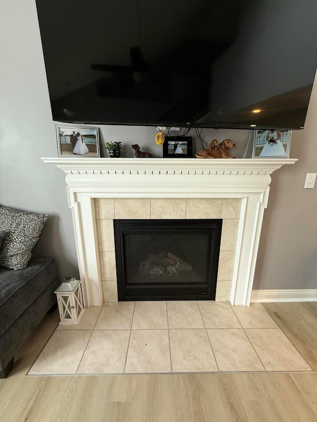 2210 Tournament Way, Grove City, OH 43123 - detailed view of a tile fireplace, wood finished floors, a ceiling fan, and baseboards
