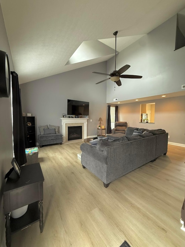 2210 Tournament Way, Grove City, OH 43123 - living area with a ceiling fan, light wood-style flooring, baseboards, a fireplace, and high vaulted ceiling