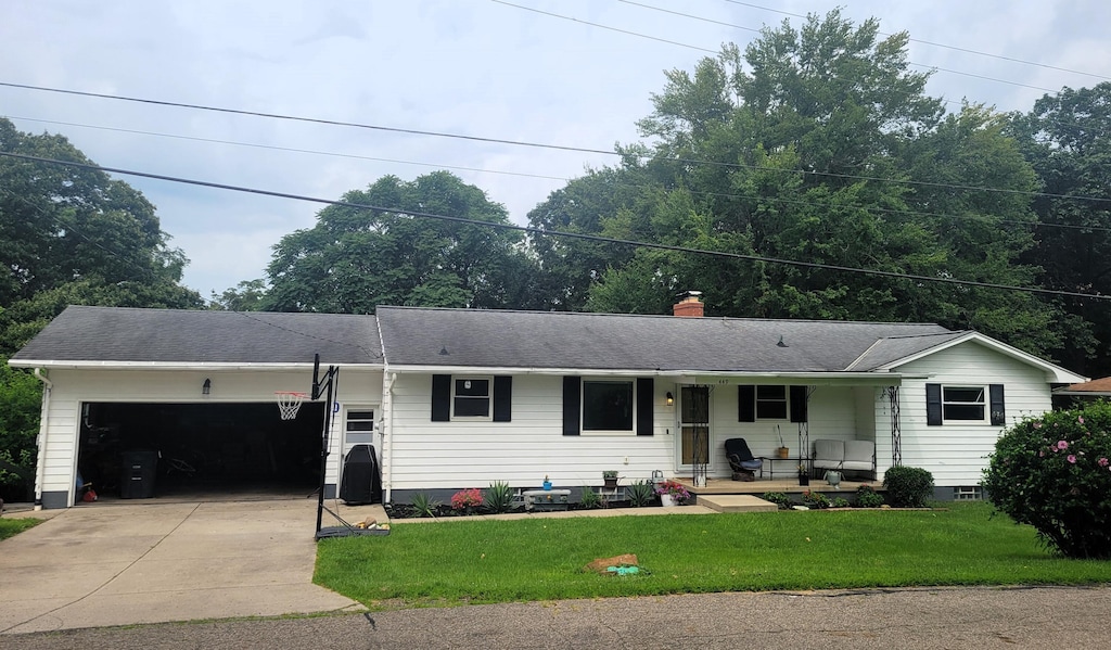 449 Lynwood Ln, Lancaster, OH 43130 - single story home with covered porch, a garage, driveway, a chimney, and a front lawn