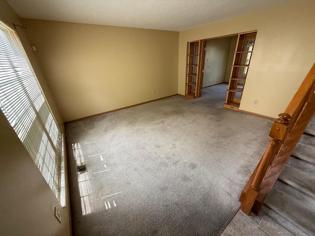 3126 Zach Ct, Columbus, OH 43219 - carpeted spare room featuring plenty of natural light, baseboards, stairway, and a textured ceiling
