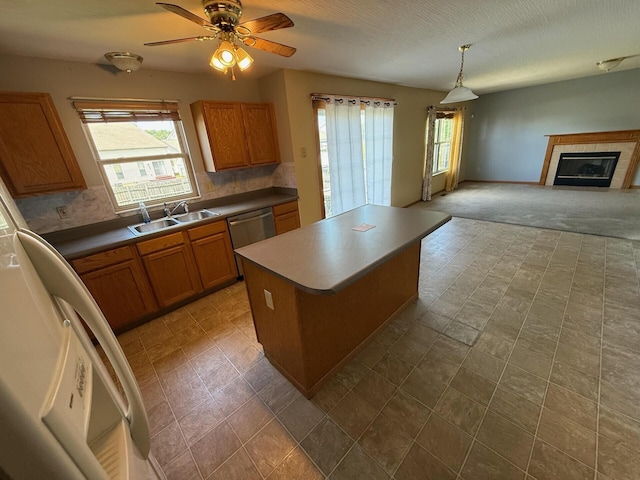3126 Zach Ct, Columbus, OH 43219 - kitchen featuring a sink, stainless steel dishwasher, healthy amount of natural light, and brown cabinetry