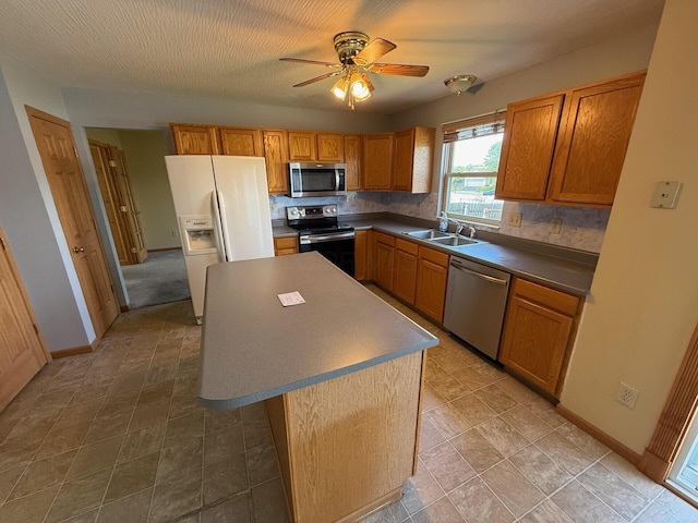 3126 Zach Ct, Columbus, OH 43219 - kitchen with appliances with stainless steel finishes, a sink, backsplash, and a center island