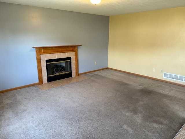 3126 Zach Ct, Columbus, OH 43219 - unfurnished living room with a tile fireplace, carpet, and baseboards