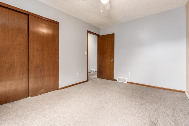 2655 Blendon Woods Blvd Unit 2644, Columbus, OH 43231 - unfurnished bedroom featuring carpet flooring, a closet, baseboards, a textured ceiling, and a ceiling fan