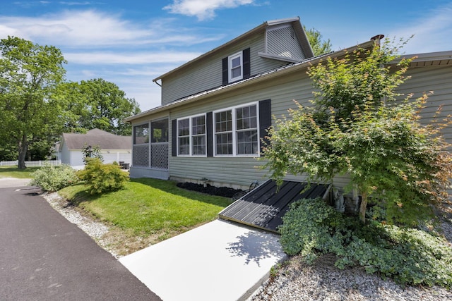 107 N Factory St, Baltimore, OH 43105 - view of front of home with a front yard and a sunroom