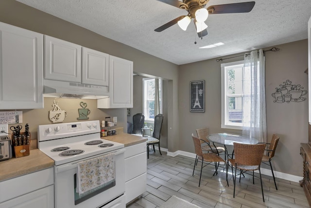 107 N Factory St, Baltimore, OH 43105 - kitchen featuring white electric range, under cabinet range hood, a ceiling fan, light countertops, and a textured ceiling