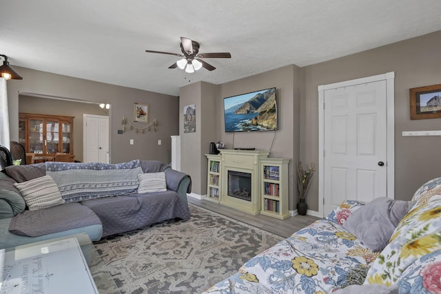 107 N Factory St, Baltimore, OH 43105 - living area with a ceiling fan, wood finished floors, and a glass covered fireplace