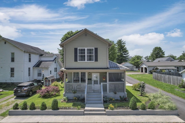 107 N Factory St, Baltimore, OH 43105 - view of front of home featuring a porch, a front lawn, a residential view, and a standing seam roof