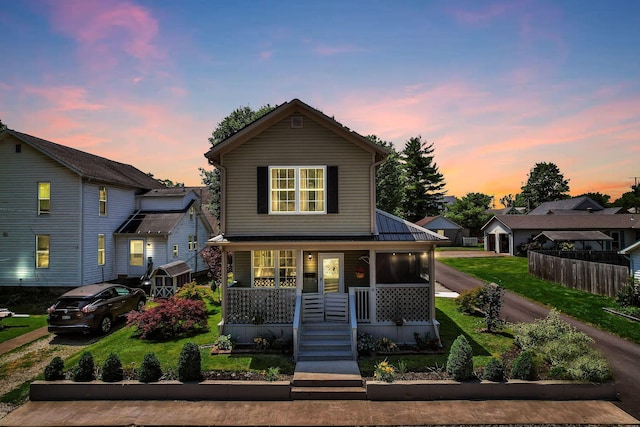 107 N Factory St, Baltimore, OH 43105 - view of front facade with a porch and a front lawn