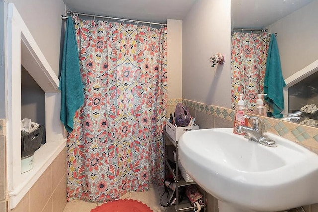 184 E Patterson Ave, Columbus, OH 43202 - bathroom featuring tile walls, tile patterned flooring, curtained shower, and a wainscoted wall