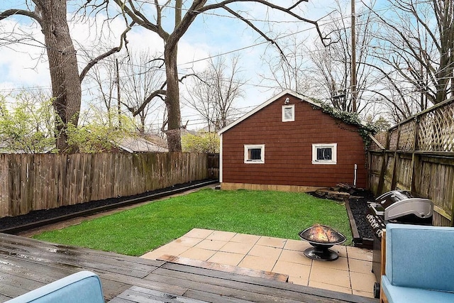 184 E Patterson Ave, Columbus, OH 43202 - fenced backyard featuring an outdoor fire pit, a wooden deck, and an outbuilding