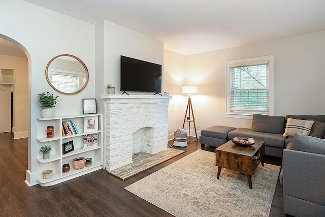 184 E Patterson Ave, Columbus, OH 43202 - living area featuring arched walkways, wood finished floors, and a fireplace