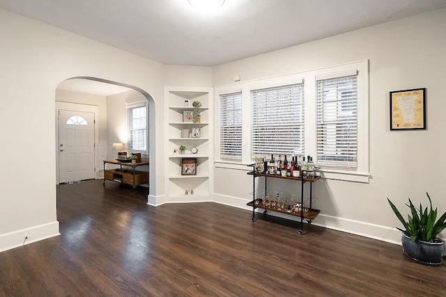 184 E Patterson Ave, Columbus, OH 43202 - dining area featuring arched walkways, built in shelves, and wood finished floors