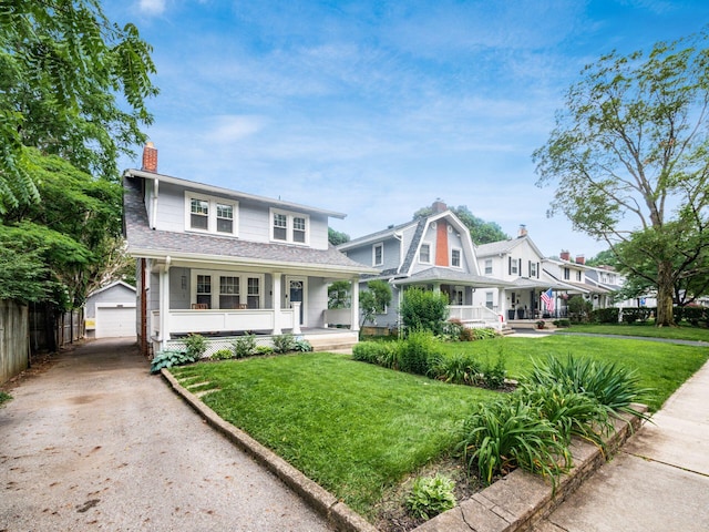 1368 Elmwood Ave, Columbus, OH 43212 - view of front of home with a porch, an outbuilding, a chimney, a detached garage, and driveway