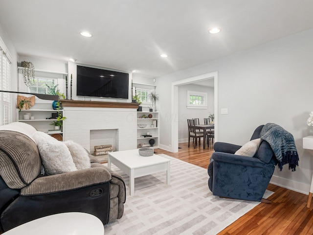 1368 Elmwood Ave, Columbus, OH 43212 - living room featuring wood finished floors, recessed lighting, and a brick fireplace