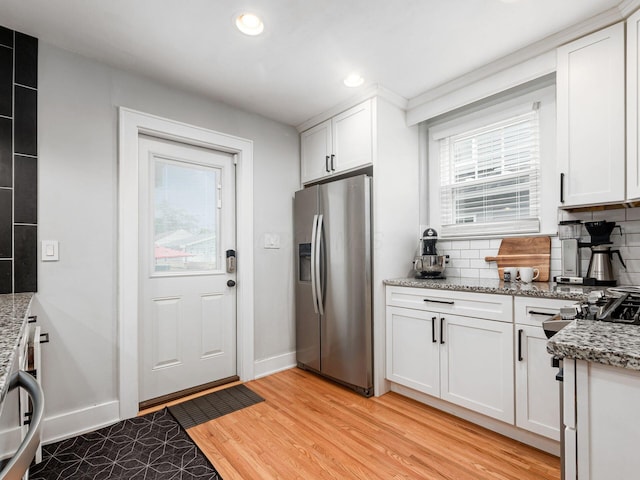 1368 Elmwood Ave, Columbus, OH 43212 - kitchen featuring stainless steel fridge with ice dispenser, backsplash, healthy amount of natural light, white cabinetry, and recessed lighting