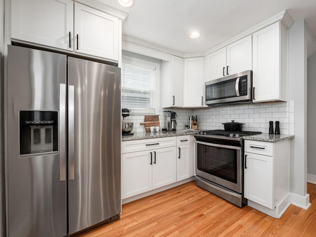 1368 Elmwood Ave, Columbus, OH 43212 - kitchen featuring stainless steel appliances, light wood-style flooring, white cabinetry, tasteful backsplash, and recessed lighting