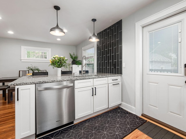 1368 Elmwood Ave, Columbus, OH 43212 - kitchen featuring stainless steel dishwasher, white cabinetry, hanging light fixtures, dark wood-style floors, and plenty of natural light