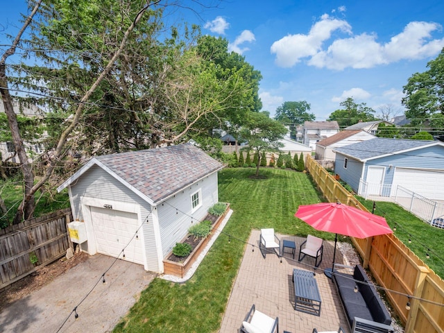 1368 Elmwood Ave, Columbus, OH 43212 - fenced backyard featuring an outbuilding, a detached garage, driveway, and outdoor lounge area