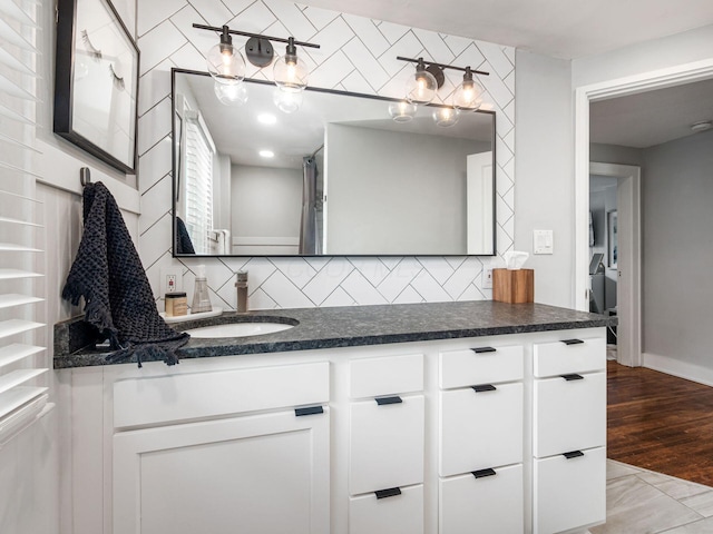 1368 Elmwood Ave, Columbus, OH 43212 - full bathroom featuring vanity, decorative backsplash, and wood finished floors