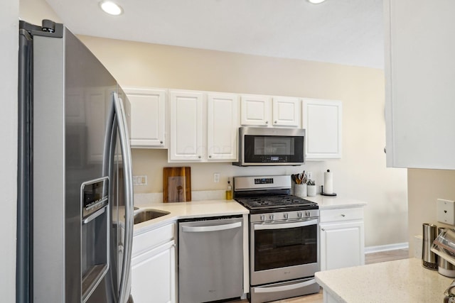 5535 Village Xing, Hilliard, OH 43026 - kitchen with appliances with stainless steel finishes, white cabinets, light countertops, and recessed lighting