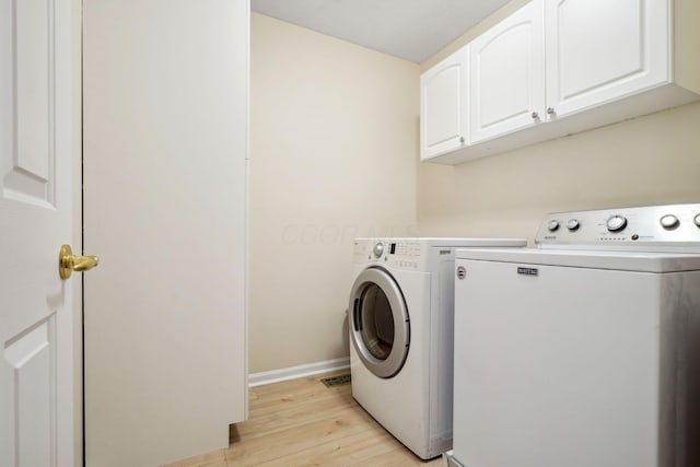 5535 Village Xing, Hilliard, OH 43026 - washroom with cabinet space, washing machine and dryer, and light wood-style floors