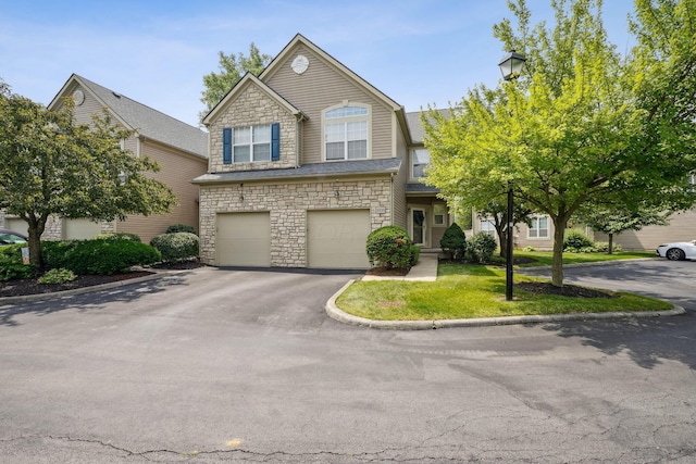 5535 Village Xing, Hilliard, OH 43026 - view of front of property featuring stone siding, asphalt driveway, and an attached garage