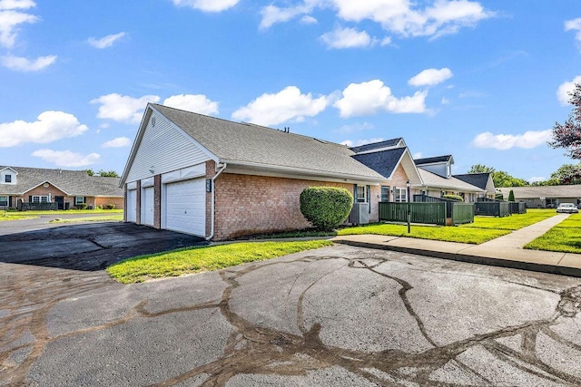 978 Kingsbury Ct, Newark, OH 43055 - view of front of home with a garage, brick siding, asphalt driveway, and a residential view