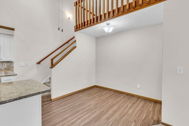 978 Kingsbury Ct, Newark, OH 43055 - unfurnished living room with light wood-style flooring and stairs