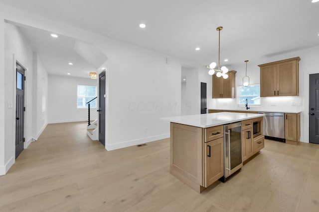 376 E Markison Ave, Columbus, OH 43207 - kitchen with stainless steel dishwasher, wine cooler, light wood-style floors, decorative backsplash, and recessed lighting