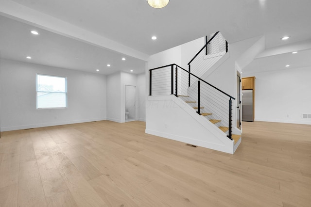 376 E Markison Ave, Columbus, OH 43207 - unfurnished living room featuring recessed lighting, stairway, and light wood-style floors