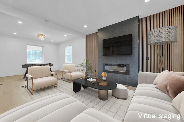376 E Markison Ave, Columbus, OH 43207 - living area featuring wood finished floors, recessed lighting, an accent wall, and a tile fireplace