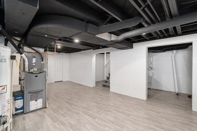 75 S Gould Rd, Columbus, OH 43209 - finished basement with light wood-type flooring, stairs, and gas water heater