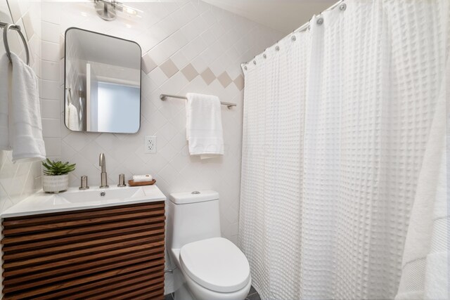 75 S Gould Rd, Columbus, OH 43209 - bathroom featuring tile walls, vanity, and a shower with shower curtain