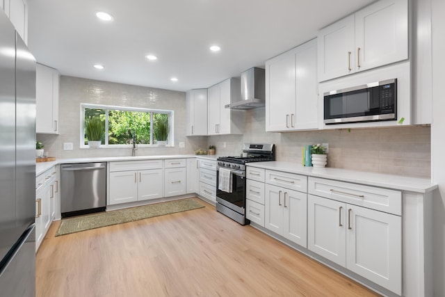 75 S Gould Rd, Columbus, OH 43209 - kitchen featuring wall chimney exhaust hood, stainless steel appliances, light countertops, and recessed lighting