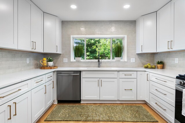 75 S Gould Rd, Columbus, OH 43209 - kitchen featuring appliances with stainless steel finishes, light wood-style floors, light countertops, tasteful backsplash, and recessed lighting