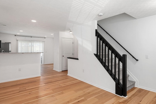 6290 Downwing Ln, Columbus, OH 43230 - stairway with wood finished floors and recessed lighting
